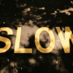 A close up of a street sign with trees in the background